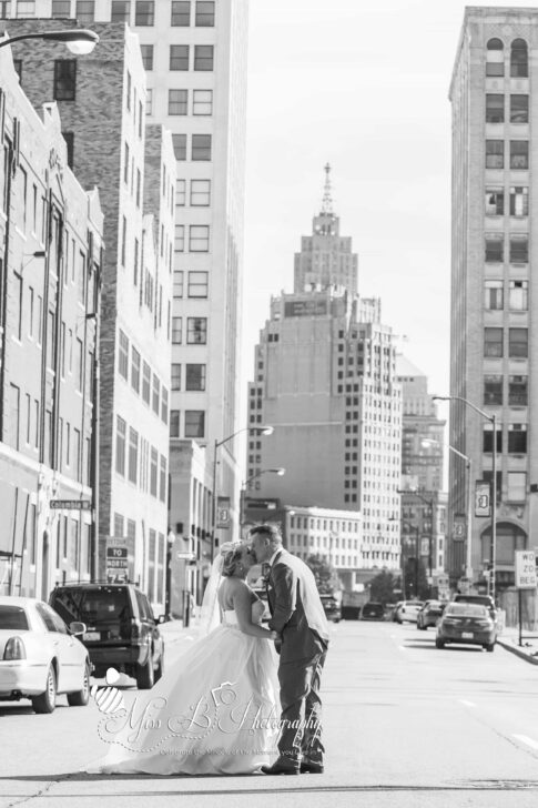 downtown detroit kissing bride and groom wedding photo black and white