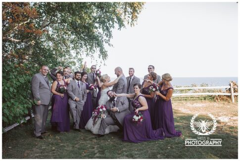 fun bridal party photo at lake huron, lexington michigan wedding, port huron michigan wedding photographer