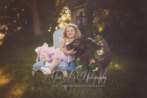 littlr girl and a mini cow port huron michigan farm photoshoot
